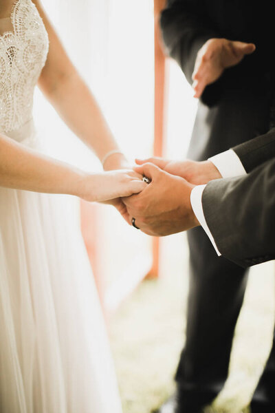 bride and groom holding hands on wedding day