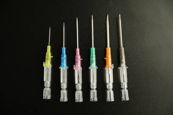 syringe and syringes on black background