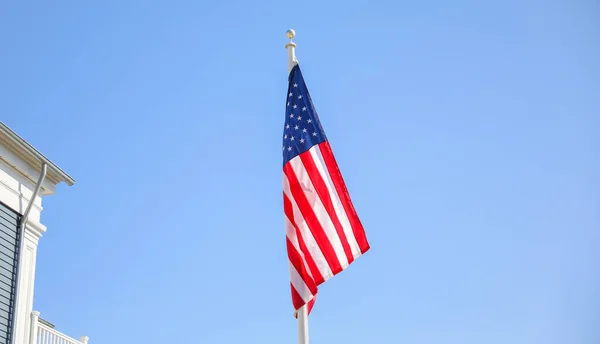 american flag on the background of the city