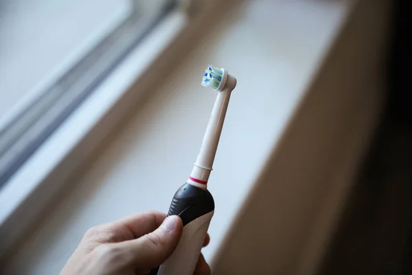 close-up of a toothbrush, symbolizing good oral hygiene. Brushing regularly helps prevent dental problems and bad breath. It represents the importance of maintaining cleanliness and hygiene