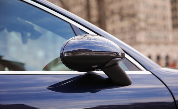 Car mirror in a stock photo symbolizes reflection, perspective, and awareness. It represents the importance of looking back, being mindful of surroundings, and gaining insights from past experiences 