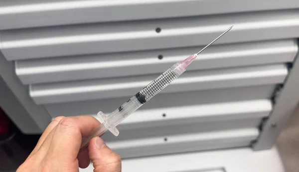 hospital setting with a close-up shot of a needle and syringe used for drugs, highlighting the opioid crisis and addiction.