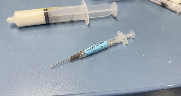 hospital setting with a close-up shot of a needle and syringe used for drugs, highlighting the opioid crisis and addiction.