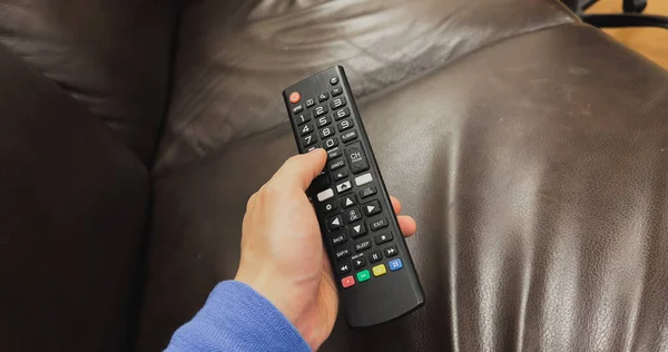 Person Holding Remote Control While Sitting Couch Watching Television Sedentary — Stock Photo, Image