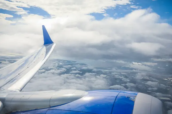 窓からの眺めは 旅行を象徴する雄大な飛行機の翼が雲の中を舞い上がる様子を捉えています 景色は視点を提供しています — ストック写真