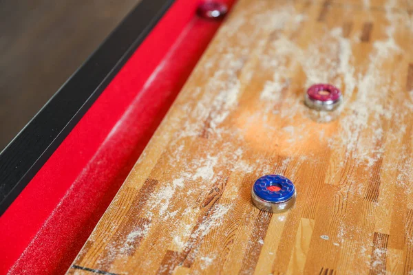 stock image Shuffleboard is a game of precision and strategy, where players slide weighted discs down a narrow court to reach scoring areas. The sport represents the pursuit of accuracy and patience