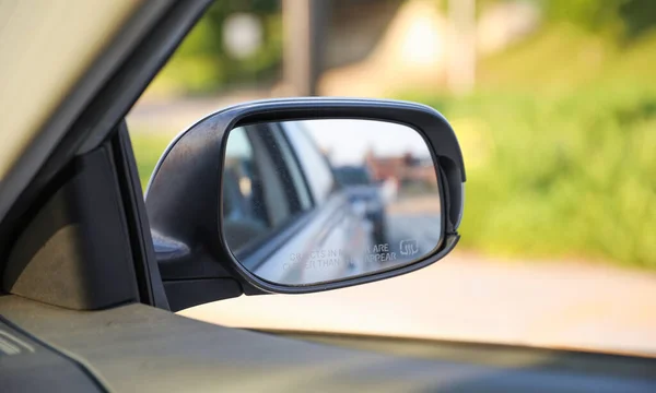 Car mirror symbolizes reflection, awareness, and safety. It represents the ability to see one\'s surroundings, check blind spots, and navigate the road with caution
