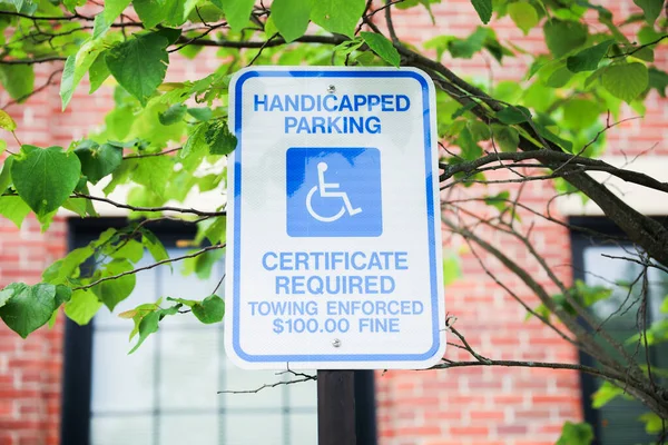 Close-up of a blue and white handicap sign, symbolizing accessibility, inclusivity, and accommodations for individuals with disabilities