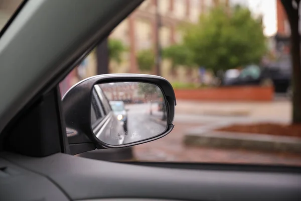 Car mirror reflects introspection, navigation, and perspective. Symbolizes self-awareness, road ahead, and the journey within. Conceptual image