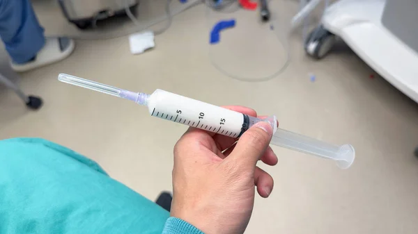 Hand Holds Syringe Amidst Drips Medications Symbolizing Medical Care Treatment — Stock Photo, Image