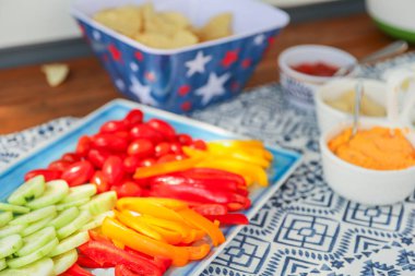 potluck spread of fresh veggies, fruits, and dips, complemented by crunchy chips, popcorn, and eggs, symbolizing diversity, nourishment, and shared experiences clipart
