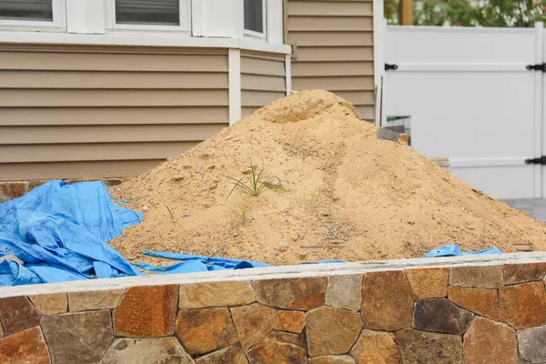 pile with sand for the construction of a house. construction of a new house. construction of a house.