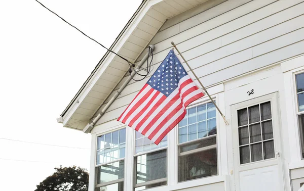 american flag hanging on a house