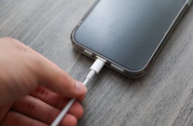 Chicago, IL, USA, Sept, 13, 2023, Fütürist USB-C iPhone şarjı: USB-C kablosu ile bağlanmış parlak bir cihaz, son teknoloji ve verimli güç dağıtımını sembolize ediyor