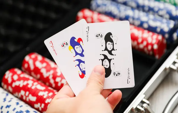 woman holding cards and playing chips, closeup
