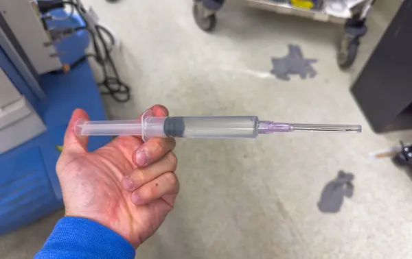a closeup shot of a syringe with a needle and a needle in the hospital