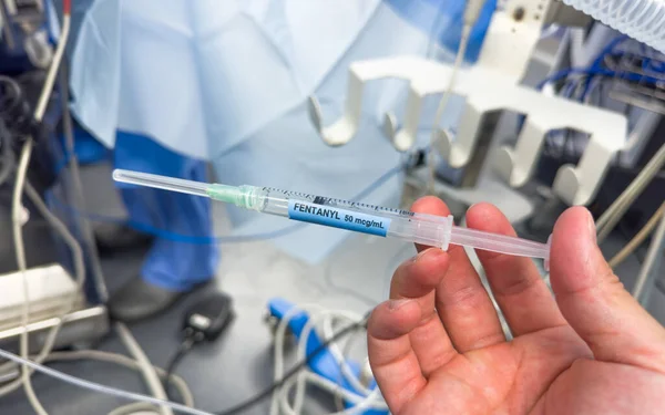 doctor holding syringe with needle in hospital
