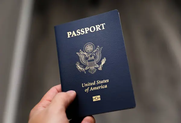 american passport in a male hand, usa