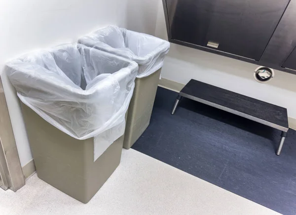 trash bin with empty trash can in the bathroom