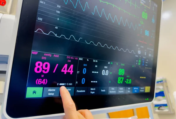 close up of patient heart monitor with blood pressure monitor in hospital