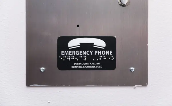 emergency call button on a white plate