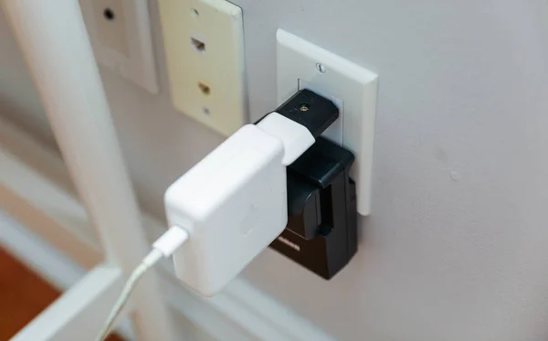 white plug with socket on the wall.