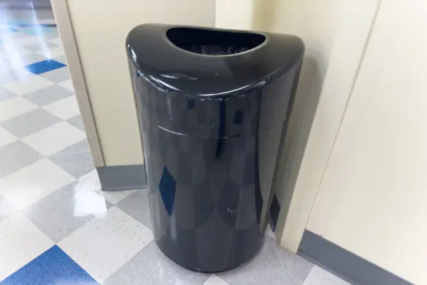 a black trash bin in the store