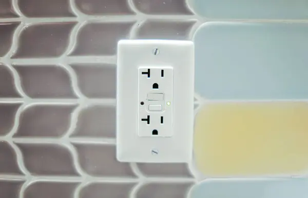 electric outlet with socket on white wall background