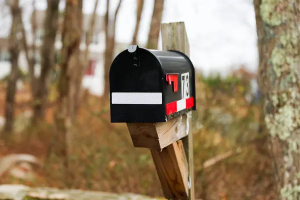 mail mail on a pole with red mailbox