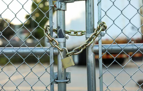 close up of metal gate with chain and lock