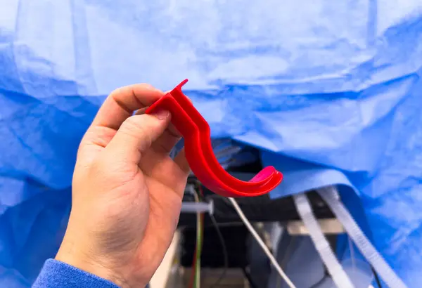 surgeon holding red ribbon in the hospital