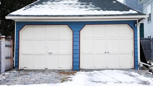 garage garage with snow covered house