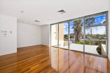 Boş oturma odası, penceresinde yeşil bir manzara var. 3d oluşturma 