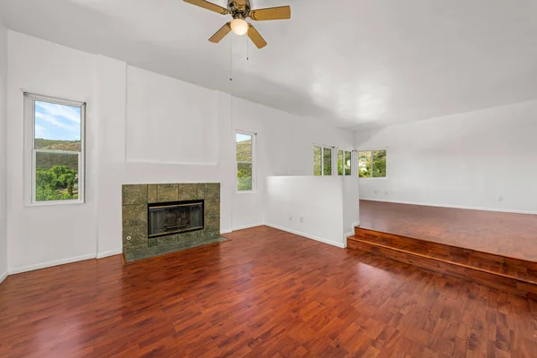 new apartment interior with hardwood flooring in living room and fireplace