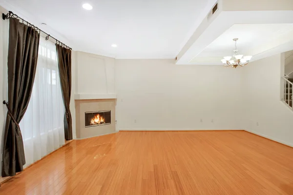 interior of a empty apartment with wooden floor and fireplace