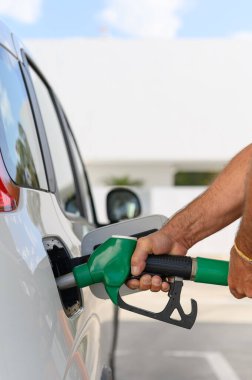 Enerji krizi sırasında yakıt ikmali yapmak için benzin pompası kullanan tanınmayan birinin fotoğrafını çek.