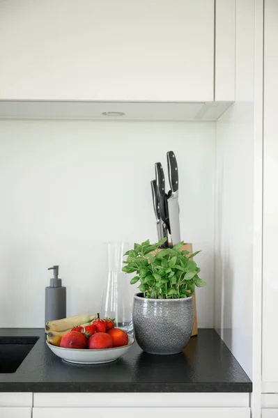 stock image Bowl with fresh fruits and vegetables placed on table in modern white kitchen at home