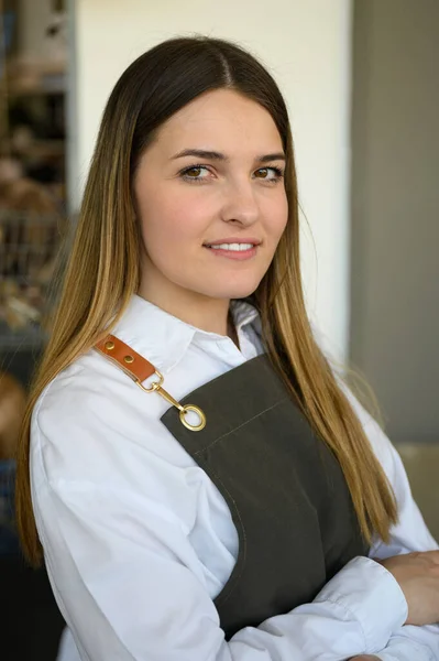 Portrait Smiling Young Woman Long Hair Crossed Arms Uniform Apron — Stock Photo, Image