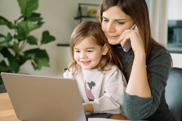 Smiling Young Girl Looks Computer Screen While Her Mother Talks — Stock Photo, Image