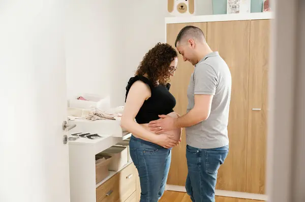 Romantic Pregnant Couple Future Baby Room Preparing Clothes — Stock Photo, Image