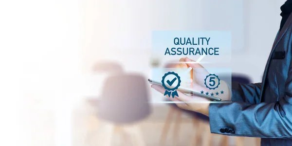 Quality Assurance Concept. Business people show high quality assurance mark, good service, premium, five stars, premium service assurance, excellence service, high quality, business excellence.