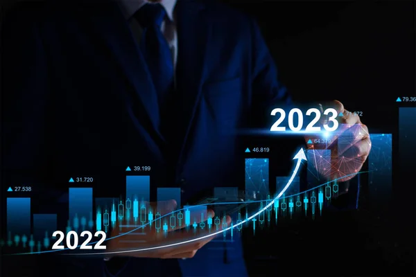 stock image Businessman analysis profitability of working companies with digital augmented reality graphics, positive indicators in 2023, businessman calculates financial data for long term investments