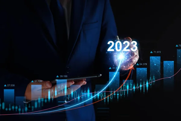 Businessman analysis profitability of working companies with digital augmented reality graphics, positive indicators in 2023, businessman calculates financial data for long term investments
