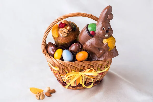 chocolate eggs, chocolate bunny and biscuits in an Easter basket