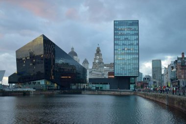 Liverpool, Merseyside, Birleşik Krallık - Ekim 12021: Arkaplanda ünlü Liverpool binası ile günbatımında konserve limanı.