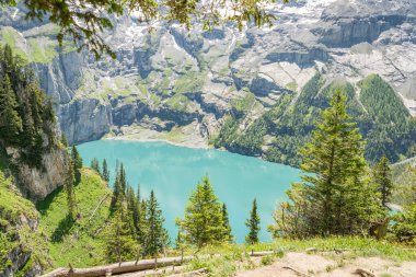 Summer view from high up in the mountains on the Oeschinensee lake in Switzerland. Swiss Alps, beautiful hiking spot around the lake. Amazing destination in the Bernese Oberland. clipart