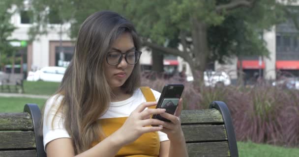 Young Woman Texting Friends Park Bench — Stock Video