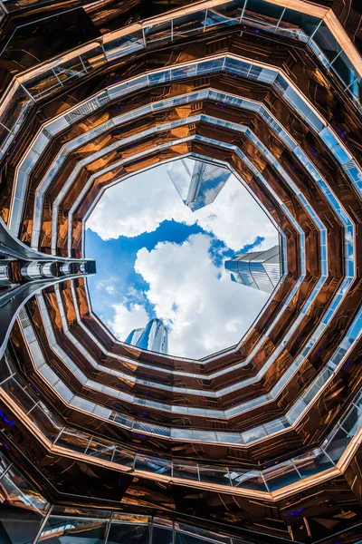 stock image The interior of the Vessel monument with skyscraper tops above