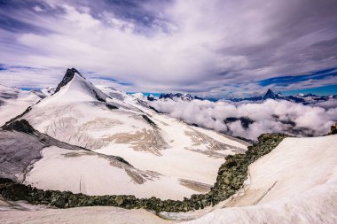 Wallis Alps peaks from the Allalinhorn Summit, Rimpfischhorn, Matterhorn and Mont Blanc in the distance. clipart