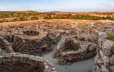 The bronze age fort UNESCO world heritage site Su Nuraxi di Barumini on Sardinia island during sunset.  clipart